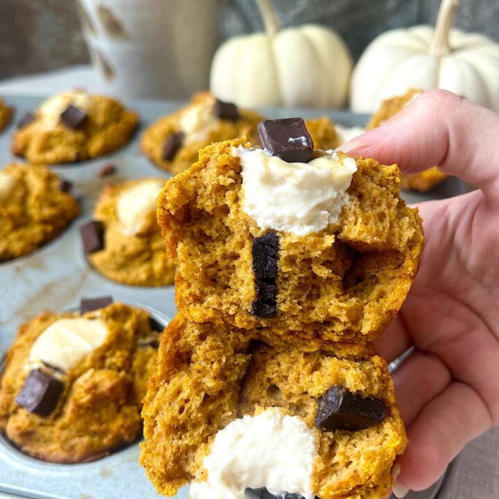 a pumpkin muffin stuffed with cream cheese broken in half