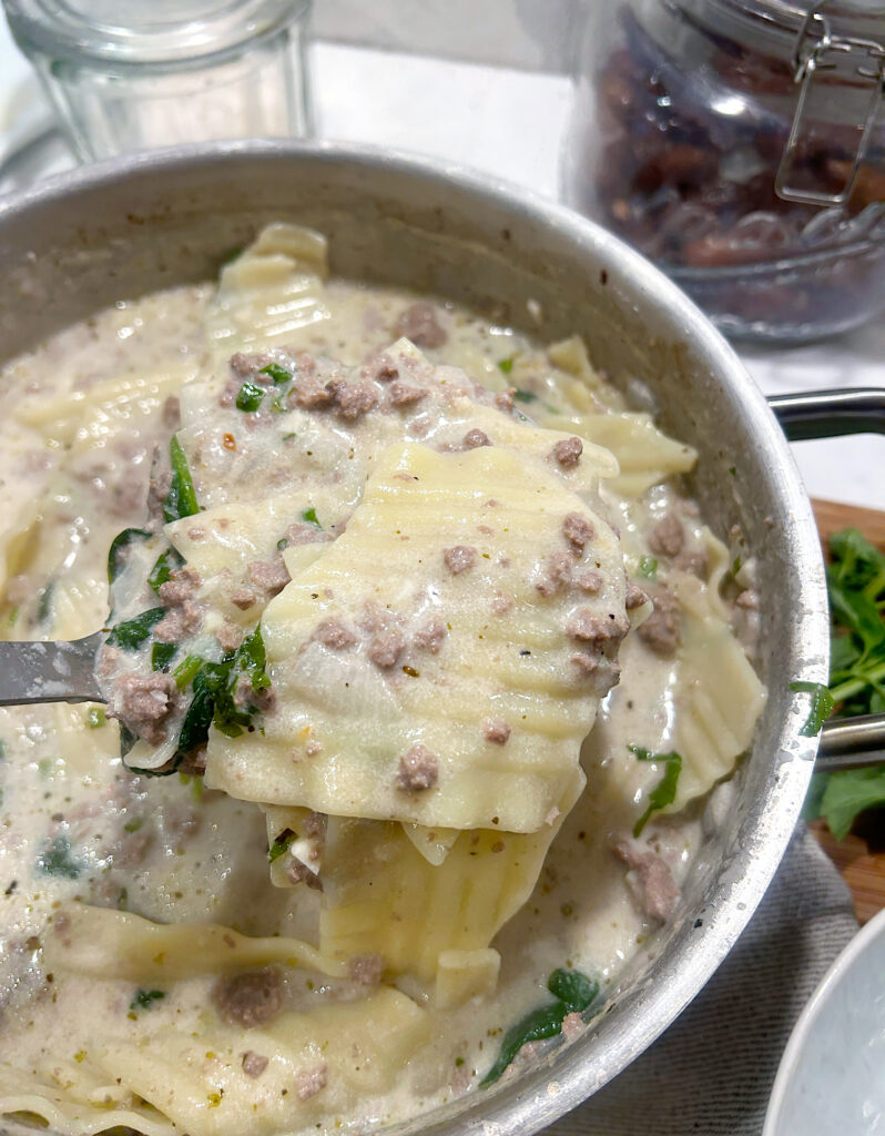 a stainless pot of white lasagna soup