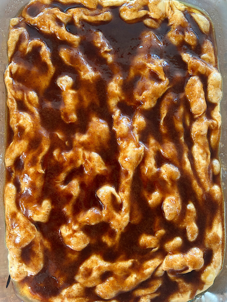 unbaked focaccia bread with cinnamon sugar butter on top